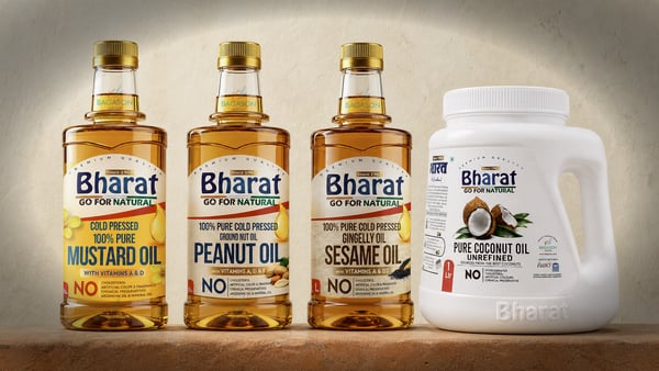Bharat cold-pressed mustard, groundnut, sesame and coconut oil bottles in a row on a warm clay surface