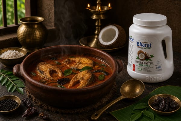 Kerala fish curry simmering beside Bharat coconut oil jar